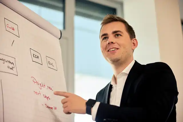 Referendar steht an einem Flipchart